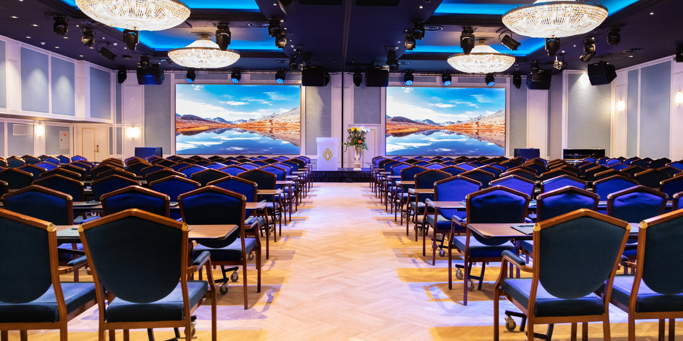 Cinema setup in Bristol Hall, with dark blue chairs and counters in each row