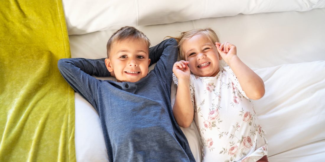 Children smiling in a hotel room