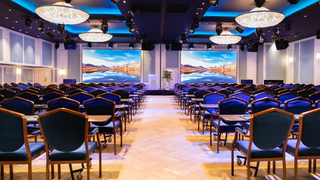 Cinema setup in Bristol Hall, with dark blue chairs and counters in each row 