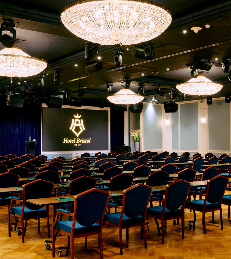Cinema setup in Bristol Hall, with dark blue chairs and counters in each row 