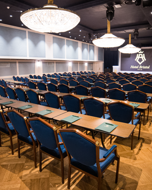 Cinema setup in spacious Maud conference area. Dark blue chairs, and counters.