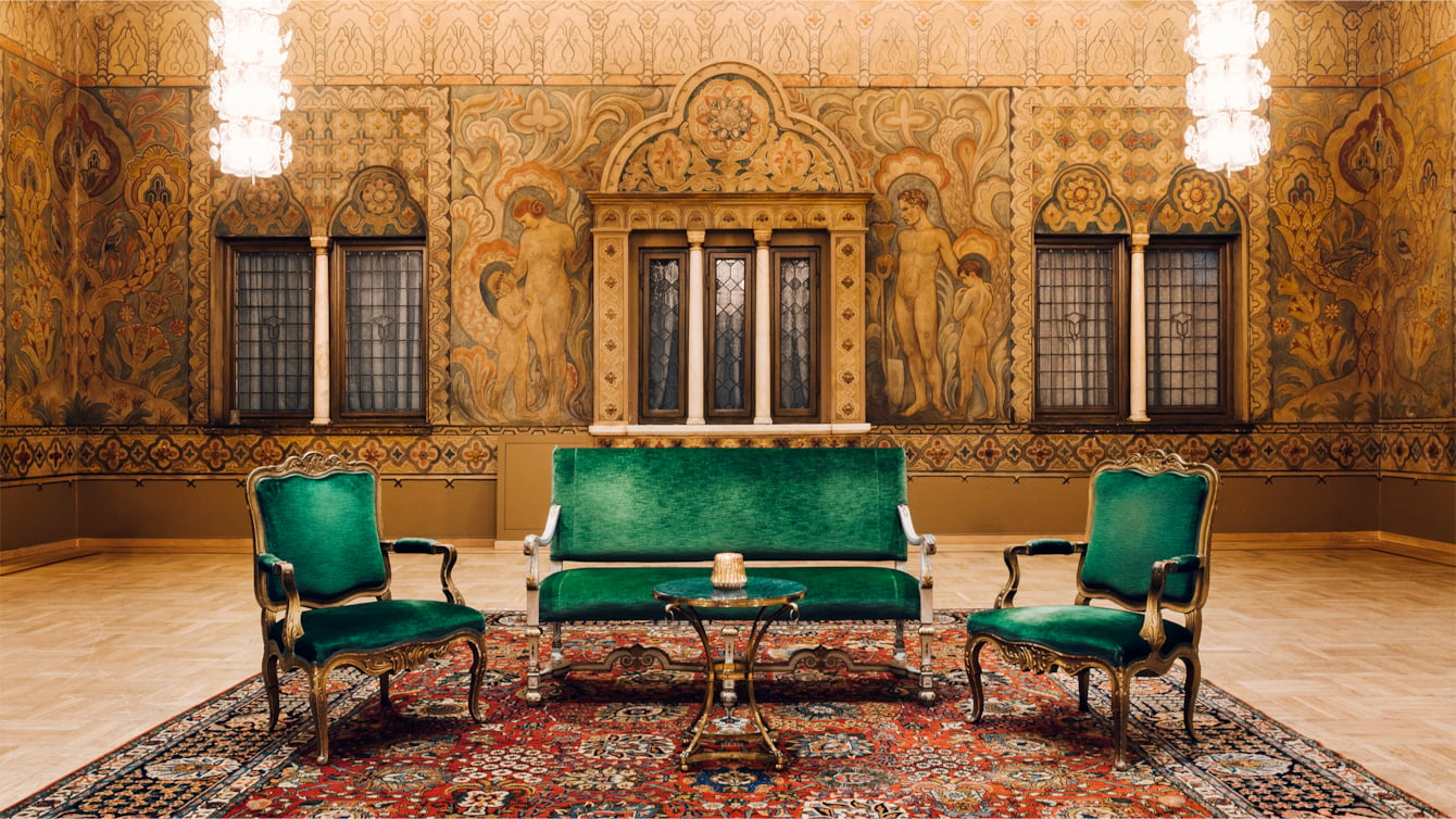 Dignified and spacious ballroom with wallpaintings and dark green furniture